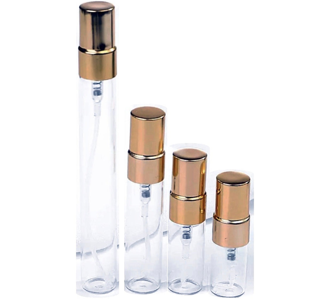 Glass perfume sample atomisers with gold caps on white background
